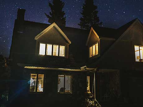 House at night with lights on.